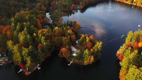Aerial-View-of-Lake-in-Picturesque-Autumn-Landscape,-Colorful-Forest-on-Lakeside-in-Rural-New-England,-Vermont-USA,-Drone-Shot