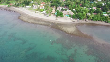 Clear-Blue-Sea-With-Waves-At-Tropical-Beach-In-Negros-Oriental,-Island-Of-Negros-In-The-Philippines---aerial-drone
