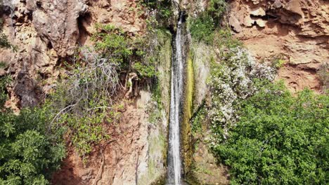 Vigario-Falls-in-Alte-town-near-Albufeira,-in-Algarve,-Portugal---Low-angle-Tilt-Up-Reveal-Aerial-shot