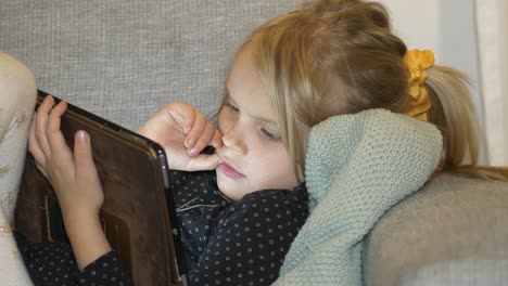 Young-Girl-Staring-At-Tablet-Screen-at-Home,-Close-Up
