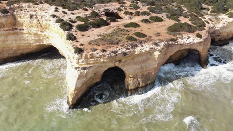 High-angle-aerial-view-of-Benagil-caves-by-the-Atlantic-ocean,-Lagoa,-Algarve,-Portugal
