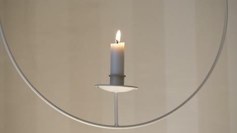 Elegant-white-candle-hanging-from-the-ceiling,-static-shot