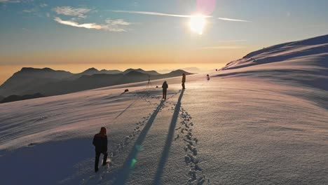A-cinematic-drone-shot-of-three-friends-walking-on-the-top-of-the-world-toward-the-sun