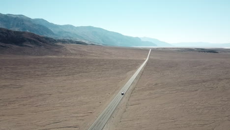 Aerial-Shot-Of-Badwater-Road-In-Death-Valley-National-Park,-Tourists-Driving-Through-Desert