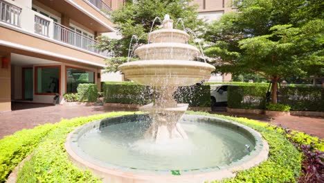 Zeitlupen-4K-Aufnahmen,-Die-Einen-Wasserbrunnen-Im-Innenhof-Eines-Hotels-In-Thailand-Umkreisen