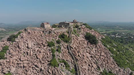 Krishnagiri-fort-standing-alone-on-a-mountain-in-India,-protecting-the-land-around-it