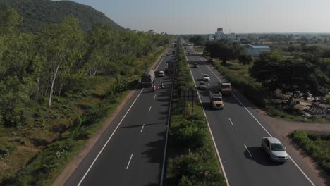 Flying-up-the-middle-lane-of-highway-in-rural-area-of-India