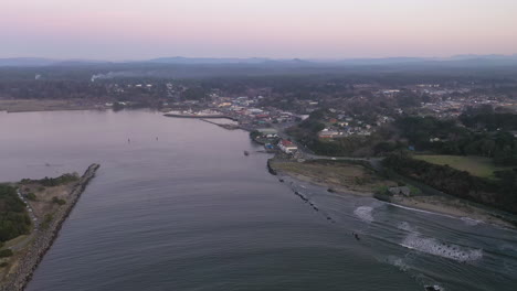 Drone-Above-Coquille-River-Flying-Towards-Bandon,-Oregon-At-Dusk---aerial