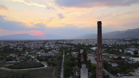 Aerial-drone-4k-clip-ascending-over-a-chimney-and-an-industrial-area-in-the-area-of-Drama-in-Northern-Greece