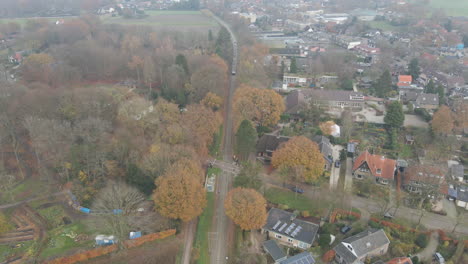 Aerial-of-approaching-train-in-small-rural-town