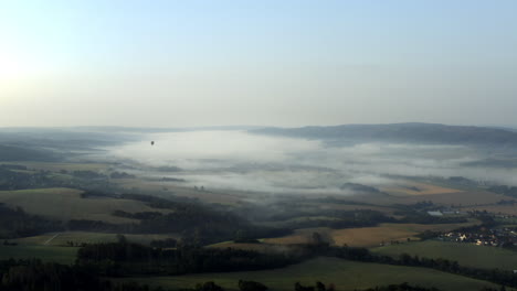 Mist-cloud-lying-over-a-field-countryside-in-Czechia,village,autumn