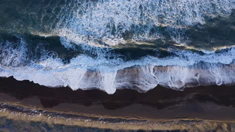 Drone-View-Of-South-Coast-Ocean-With-Black-Sand-And-Waves---aerial-ascending