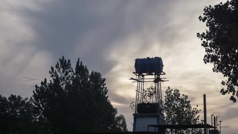 Time-lapse-of-cloudy-day-landscape-with-water-tank-tower