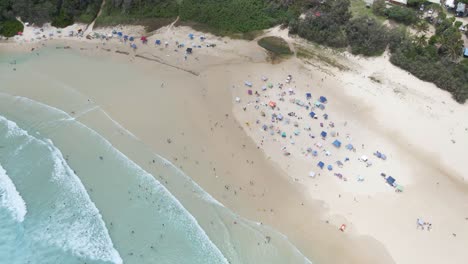 Tents-Build-On-The-Sandy-Shore-Of-Beach-For-Campground---People-At-Cylinder-Beach,-Minjerribah,-QLD,-Australia