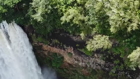 Drone-aerial-waterfall-pan-down-rainbow-forest