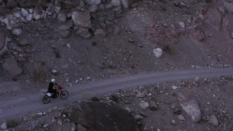Motorcyclists-ride-fast-on-serpentines-on-a-broken-mountain-road