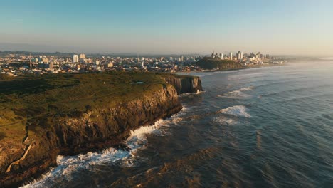 Aerial-cinematic-shot-of-high-rocky-cliffs-on-atlantic-ocean,-Torres,-Rio-Grande-do-Sul,-Brazil