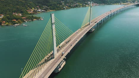 Amazing-establishing-aerial-shot-along-Anita-Garibaldi-bridge-above-the-ocean,-located-in-Laguna,-Santa-Catarina,-Brazil