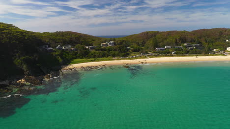 Aerial-shot-of-Seal-Rocks-main-beach-on-Australian-coastline,-summer-day