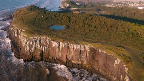 Beautiful-aerial-top-down-view-of-high-cliffs-on-atlantic-ocean,-Brazilian-Conservation-Unit-located-in-the-southern-region,-State-of-Rio-Grande-do-Sul,-Torres-City