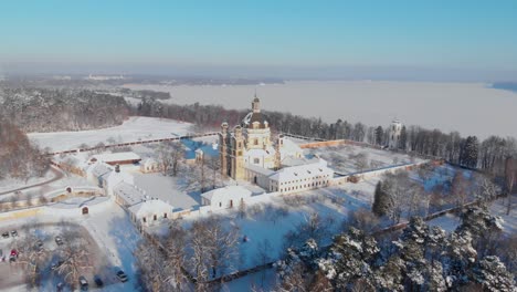 Aerial-view-of-the-Pazaislis-monastery-and-the-Church-of-the-Visitation-in-Kaunas,-Lithuania-in-winter,-snowy-landscape,-Italian-Baroque-architecture,-zooming-in,-zoom-in,-dolly-zoom