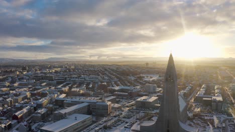 Epic-sunrise-at-capital-city-of-Iceland-with-famous-Hallgrímur-church,-aerial