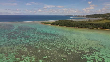 Aerial-shot-pan's-up-and-over-the-Pacific-Ocean-to-the-Island-of-Guam