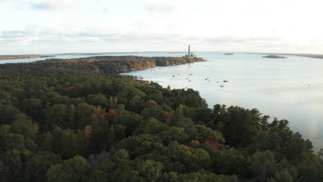 Aerial-Drone-Footage-flying-towards-Cousins-Island-Wyman-Power-Plant-from-forest-tree-top
