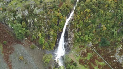 Idyllic-Snowdonia-mountain-range-Aber-falls-waterfalls-national-park-aerial-view-high-rising-tilt-up