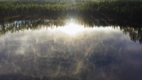 Aerial-drone-footage-of-pristine-misty-forest-lake-in-the-morning