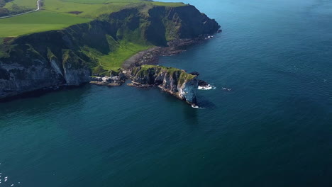 Aerial-shot-of-Kinbane-Castle-in-County-Antrim,-Northern-Ireland,-on-a-long,-narrow-limestone-headland-projecting-into-the-sea