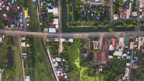 AERIAL:-Drone-Panning-left-to-right-high-above-Residential-Blocks-Separated-by-Highway-in-Densely-Populated-Nakhon-Ratchasima-Town-in-Korat-Province,-Thailand-Asia