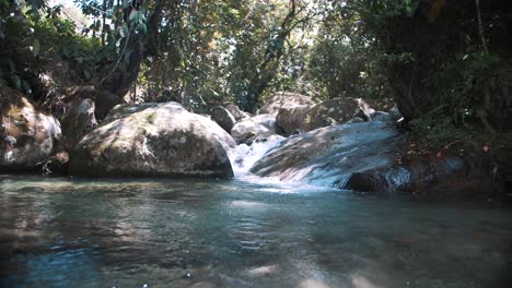 Beautiful-slow-motion-shot-of-water-flowing,-small-cascades-in-the-jungle