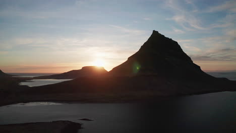 Sunset-behind-the-beautiful-Kirkjufell-mountain-in-West-Iceland--aerial