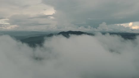 Drone-aerial,-beautiful-misty-cloudy-landscape,-over-the-clouds-in-Guatemala