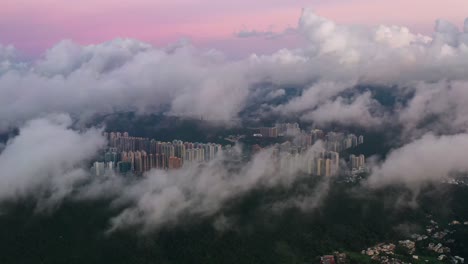 Skyscrapers-peeking-through-sunrise-cloud-cover-aerial-view-over-Clear-Water-Bay-island-Hong-Kong