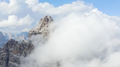High-quality-rotating-Aerial-of-Mountain-Top-covered-in-white-clouds-4K-video,-Tre-Cime-di-Lavaredo,-Italy