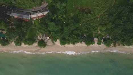 Aerial-birds-eye-view-of-a-popular-tourist-beach-destination-with-beach-bungalow-resort,-no-tourists-on-the-beach-in-Thailand-due-to-the-effect-of-covid-on-global-travel-and-tourism