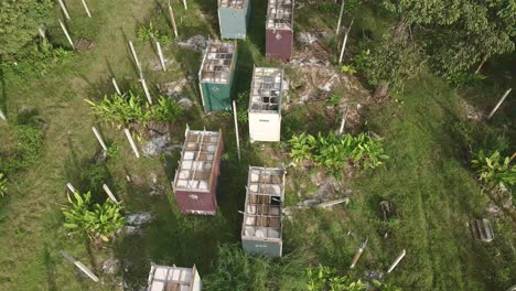 Aerial-birds-eye-view-side-trucking-shot-of-a-abandoned-and-derelict-beach-bungalow-tourist-resort-in-Koh-Chang-Thailand-due-to-the-effect-of-covid-on-global-travel-and-tourism