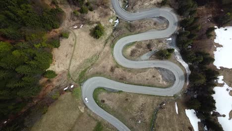 Iconic-mountain-roads-winding-through-French-Alps,-aerial-view