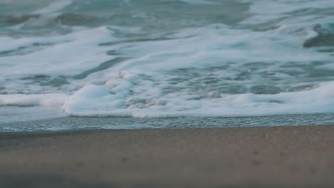 beautiful-foamy-waves-crashing-on-the-sand---close-up-slow-motion-shot