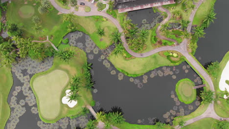 Top-down-aerial-view-of-water-feature-and-green-on-golf-course
