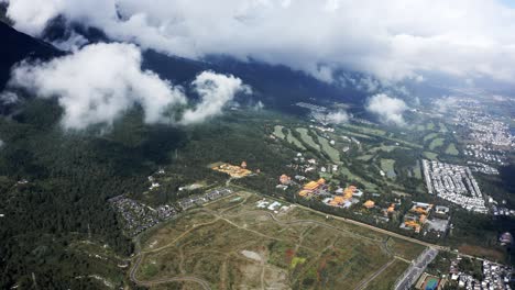 Dali-city-sprawling-across-Cangshan-Mountains-valley,-high-aerial-view