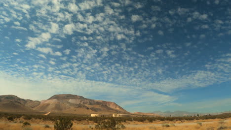 Looking-out-the-window-at-scenery-while-driving-along-the-Mojave-Desert-landscape