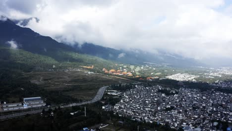 Chinese-Dali-city-on-Cangshan-Mountains-hillside,-high-aerial-view