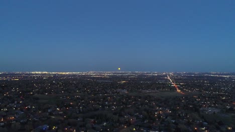 Un-Vuelo-De-Drones-En-El-Crepúsculo-Civil-Capturando-Una-Luna-De-Halloween-Que-Se-Eleva-Sobre-Denver-Co