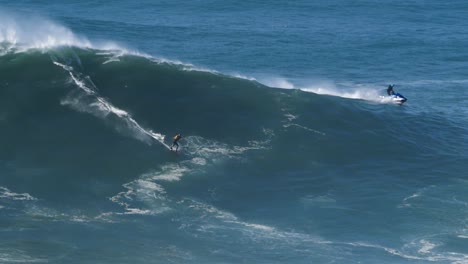 Slow-motion-of-a-big-wave-surfer-riding-a-crazy-wave-in-Nazaré,-Portugal