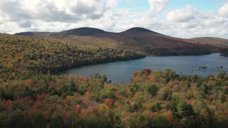 Picturesque-Landscape-and-Lake-in-Maine-USA-on-Sunny-Autumn-Day,-Aerial-View-of-Colorful-Forest-and-Water-Under-Beautiful-Sky
