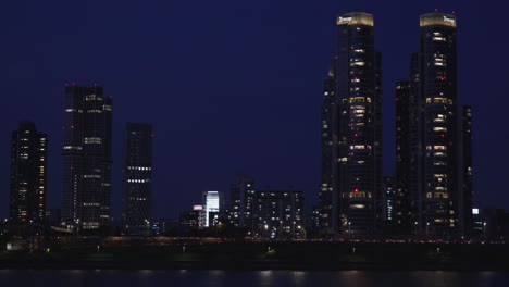 Nighttime-in-Seoul-with-tall-skyscrapers-isolated-on-dark-night-sky