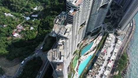 Hong-Kong-Cyberport-waterfront-park-luxury-residential-buildings,-Aerial-view